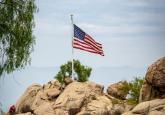 Photo by Get Lost Mike: https://www.pexels.com/photo/a-flag-on-a-rock-formation-9012267/