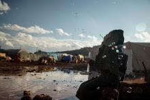 Photo by Khaled Akacha: https://www.pexels.com/photo/hijabi-woman-kneeling-by-puddle-in-refugee-camp-blowing-bubbles-10613996/