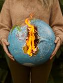 Photo by ArtHouse Studio: https://www.pexels.com/photo/a-person-wearing-a-brown-sweater-holding-a-burning-globe-4310289/